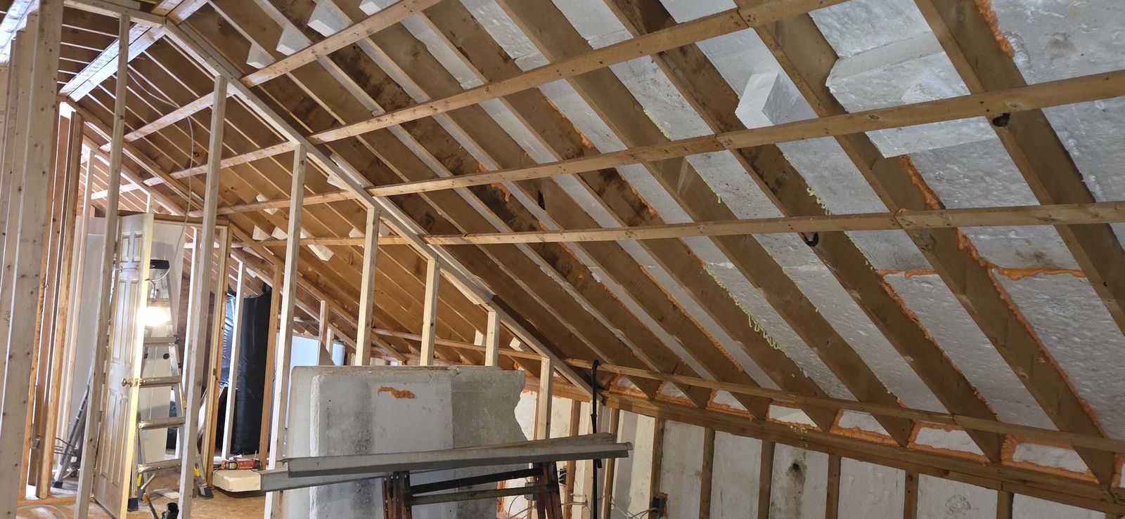 Attic with new wall framing and insulation between the rafters