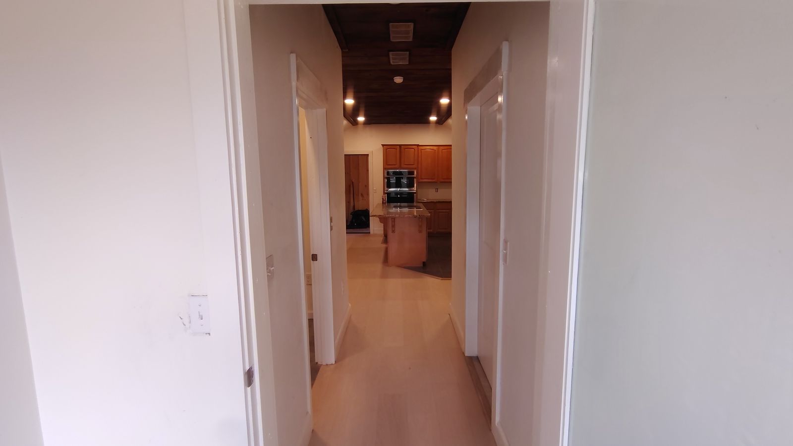 View down a hallway into the finished kitchen