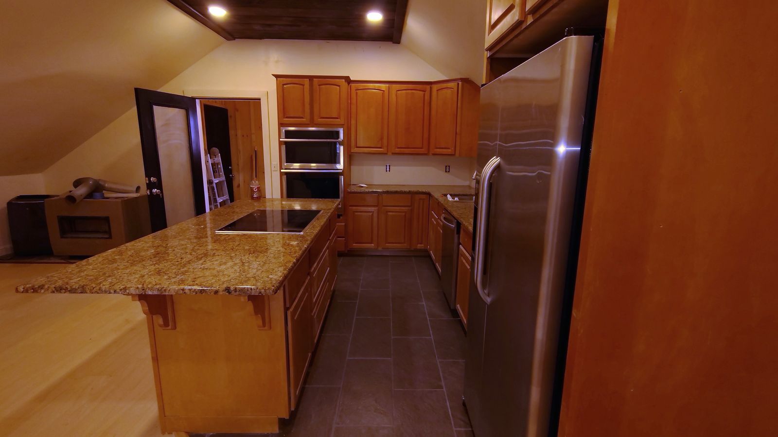 Kitchen island with a granite top and built-in cooktop