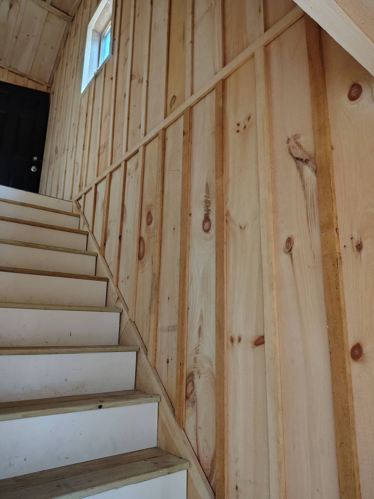Stairwell finished in knotty pine board-and-batten