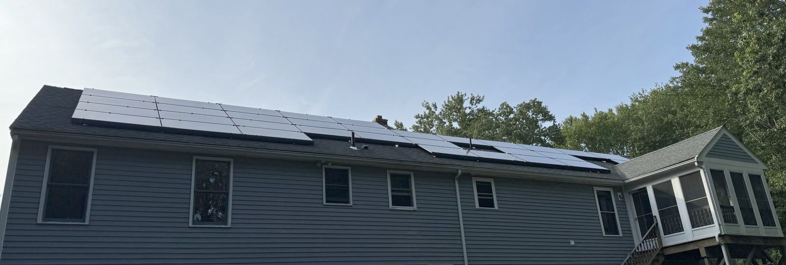 Long solar array across the back roof of a two-story home